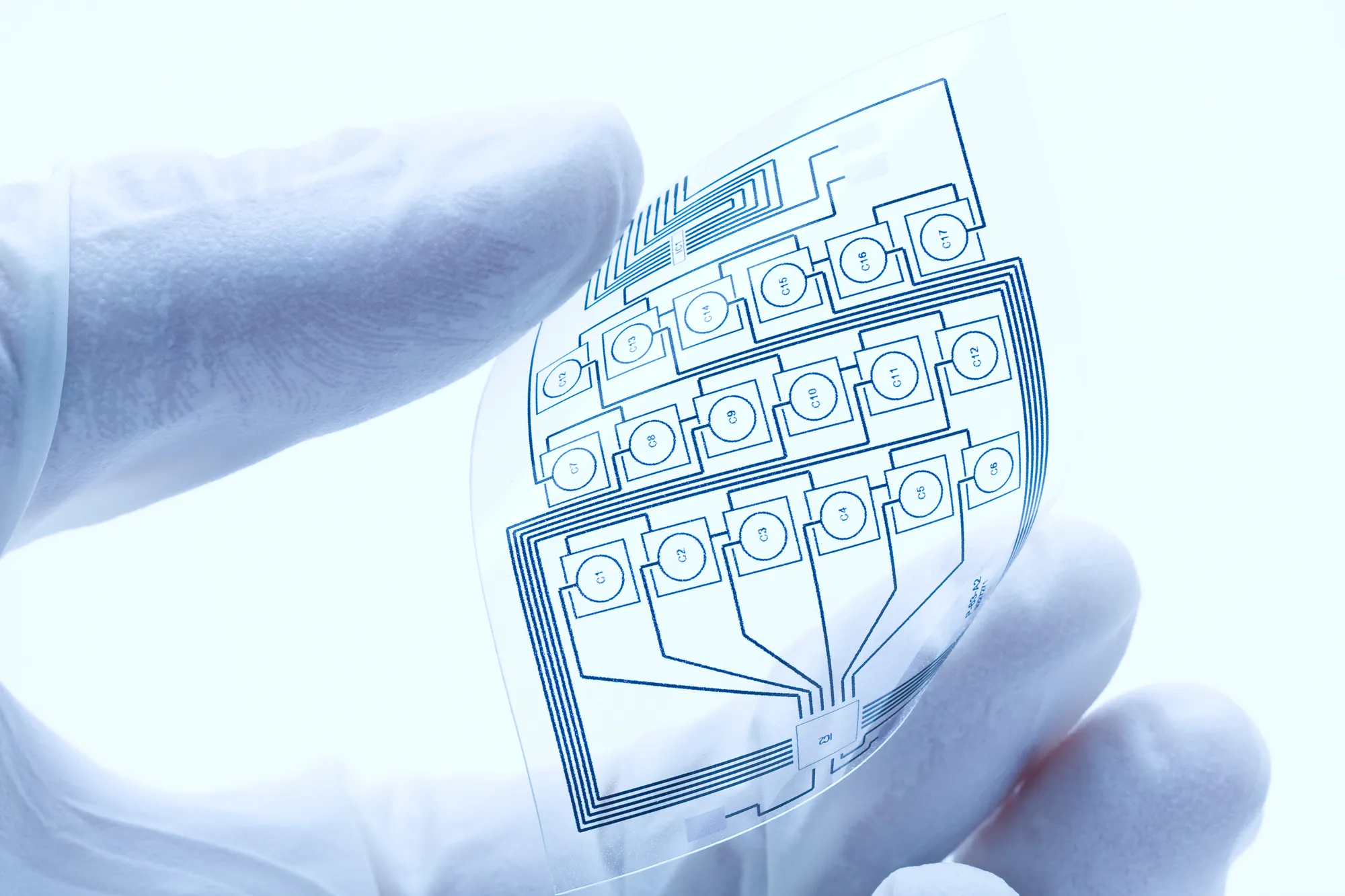 Flexible electronic circuit patterned on a transparent ultra-thin polyimide film, representing high‑performance electronics used in data center environments.